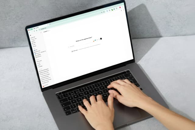 Person typing on a laptop using the ChatGPT interface on screen.