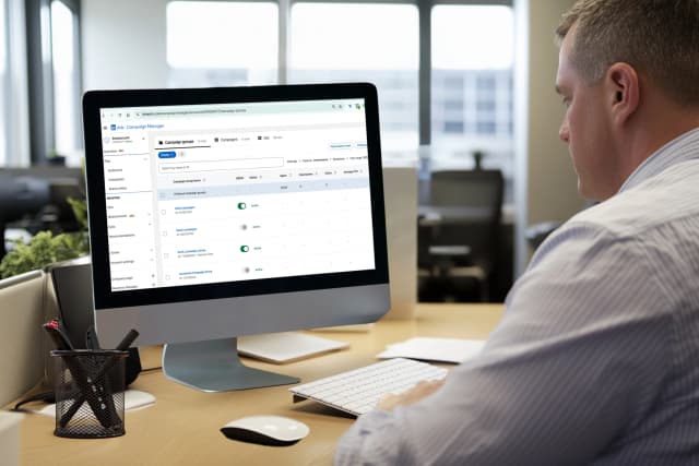 Woman presenting a social media marketing strategy to a team in a modern meeting room.